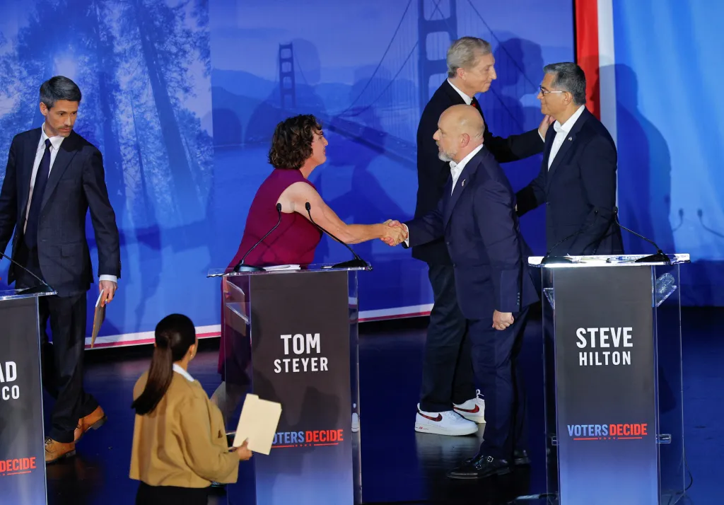 Steve Hilton and Katie Porter shake hands after the California gubernatorial debate, as Tom Steyer and Xavier Becerra also shake hands.