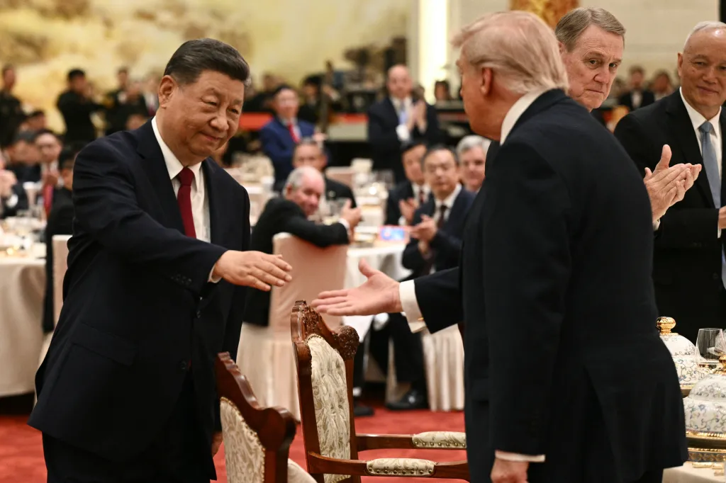 China's President Xi Jinping shakes hands with US President Donald Trump.
