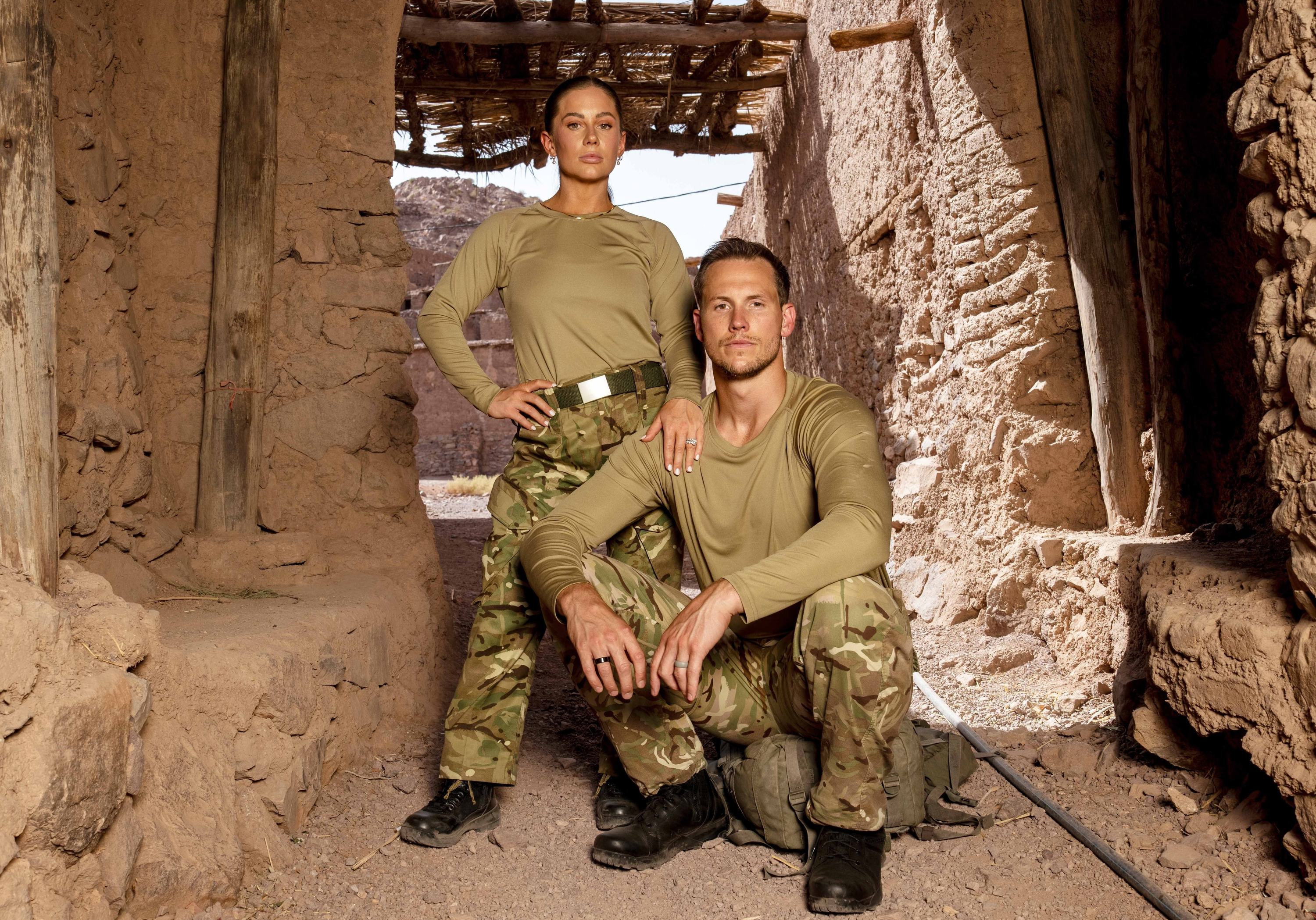 Shawn Johnson East and Andrew East posing in military-style uniforms.