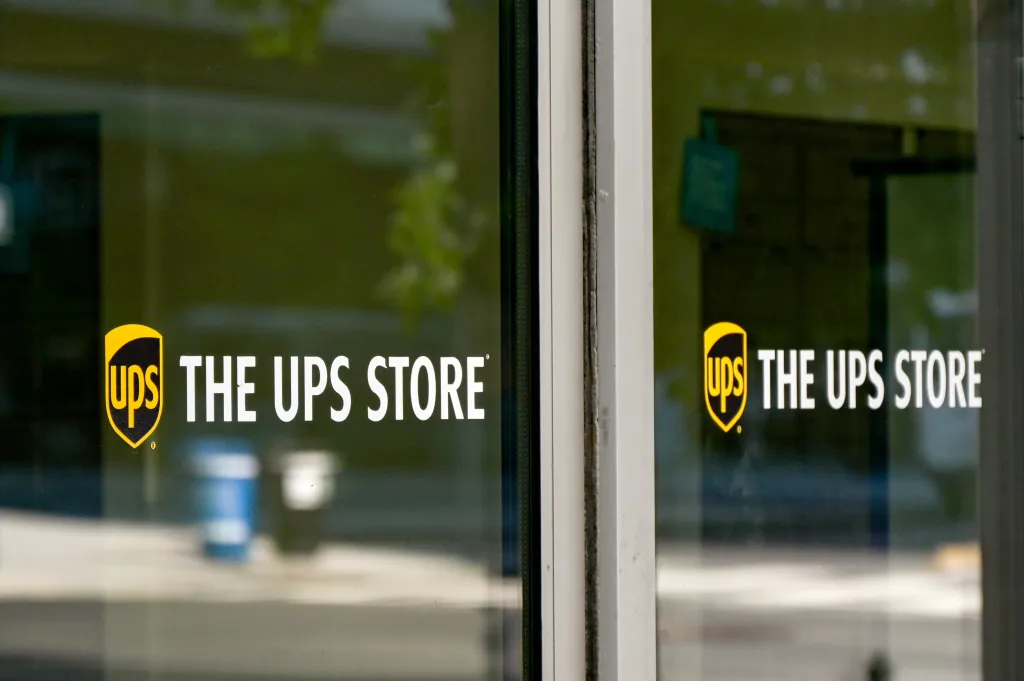 The UPS Store sign on the glass entrance of a building.