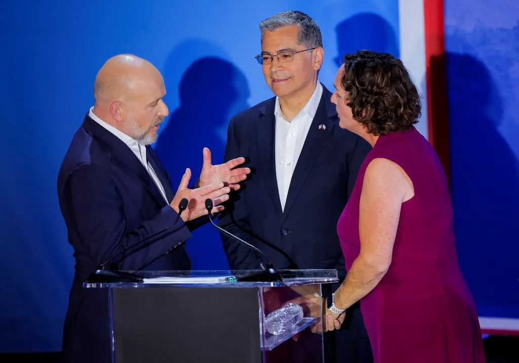 Candidates Katie Porter and Steve Hilton speak while Xavier Becerra looks on during a gubernatorial debate.