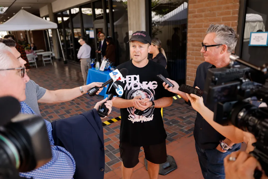 Spencer Pratt speaking to reporters with microphones from ABC and NBC in Los Angeles after filing his Declaration of Intention to become a candidate for LA Mayor.