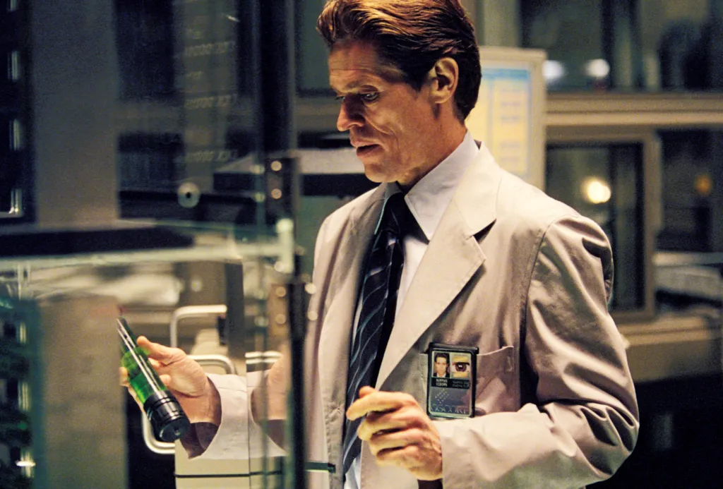 Willem Dafoe as Norman Osborn from Spider-Man holding a green vial.