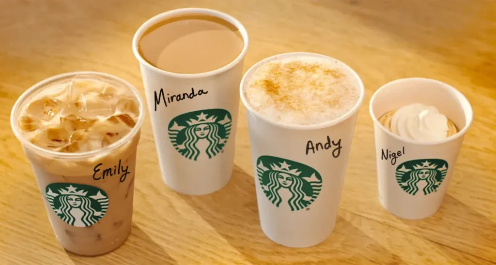 Four Starbucks drinks named Emily, Miranda, Andy, and Nigel.