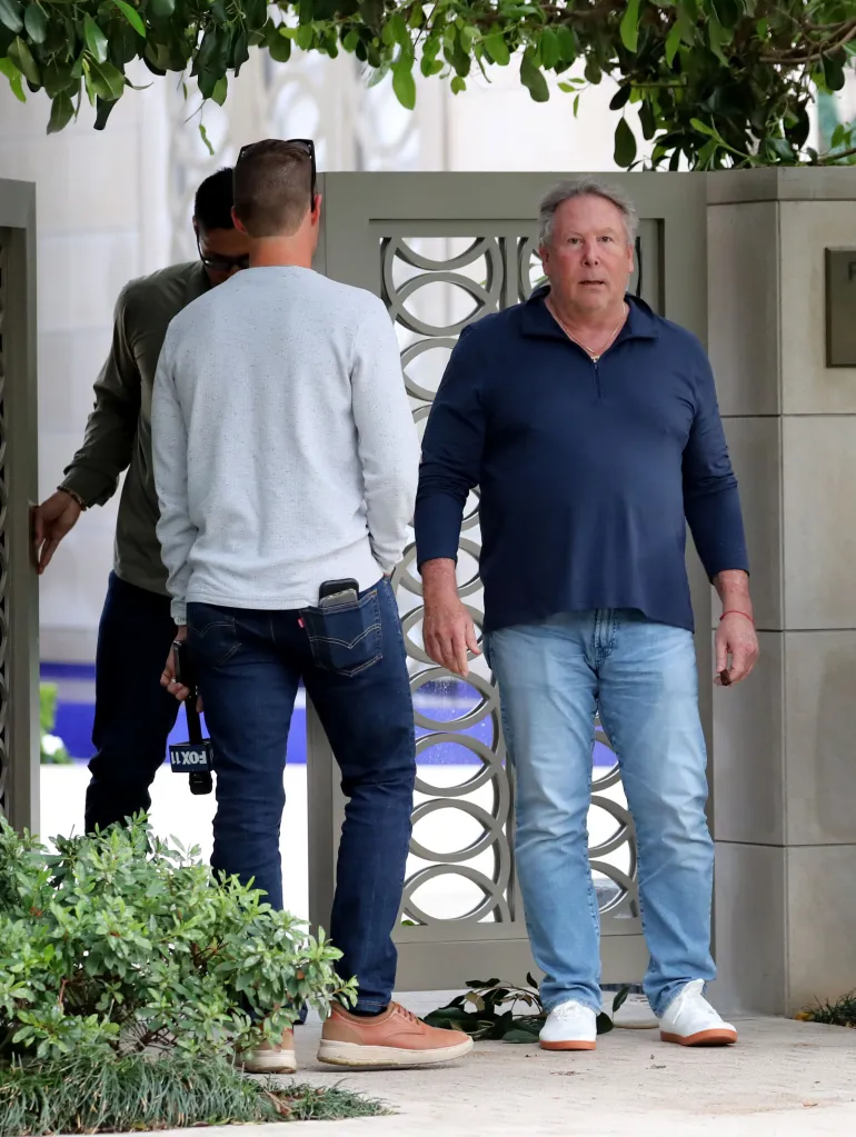 Stephen Cloobeck speaking to a news crew outside his mansion.