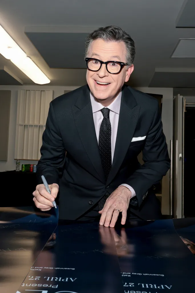 Stephen Colbert signing autographs.