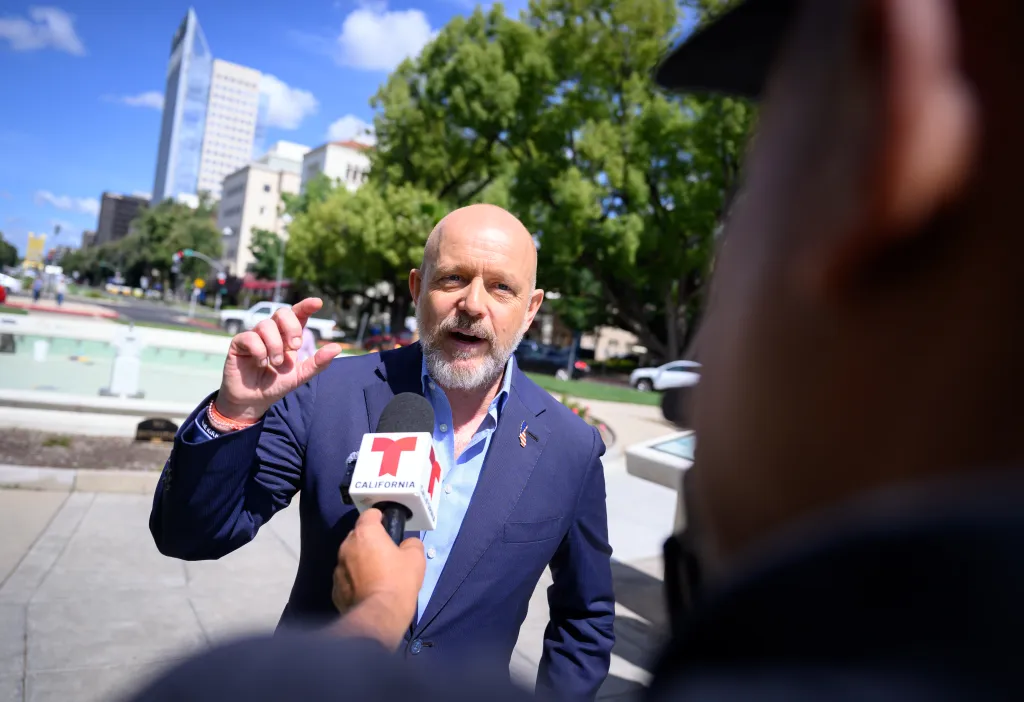 Steve Hilton, a Republican candidate, is speaking into a 