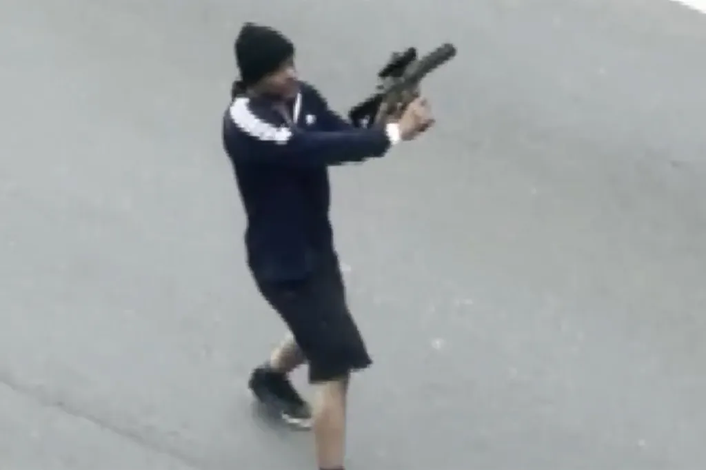 A still frame from a witness video showing a gunman on Memorial Drive in Cambridge, Massachusetts.