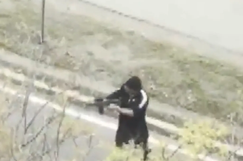 Still frame from witness video showing a gunman on Memorial Drive in Cambridge, Massachusetts.