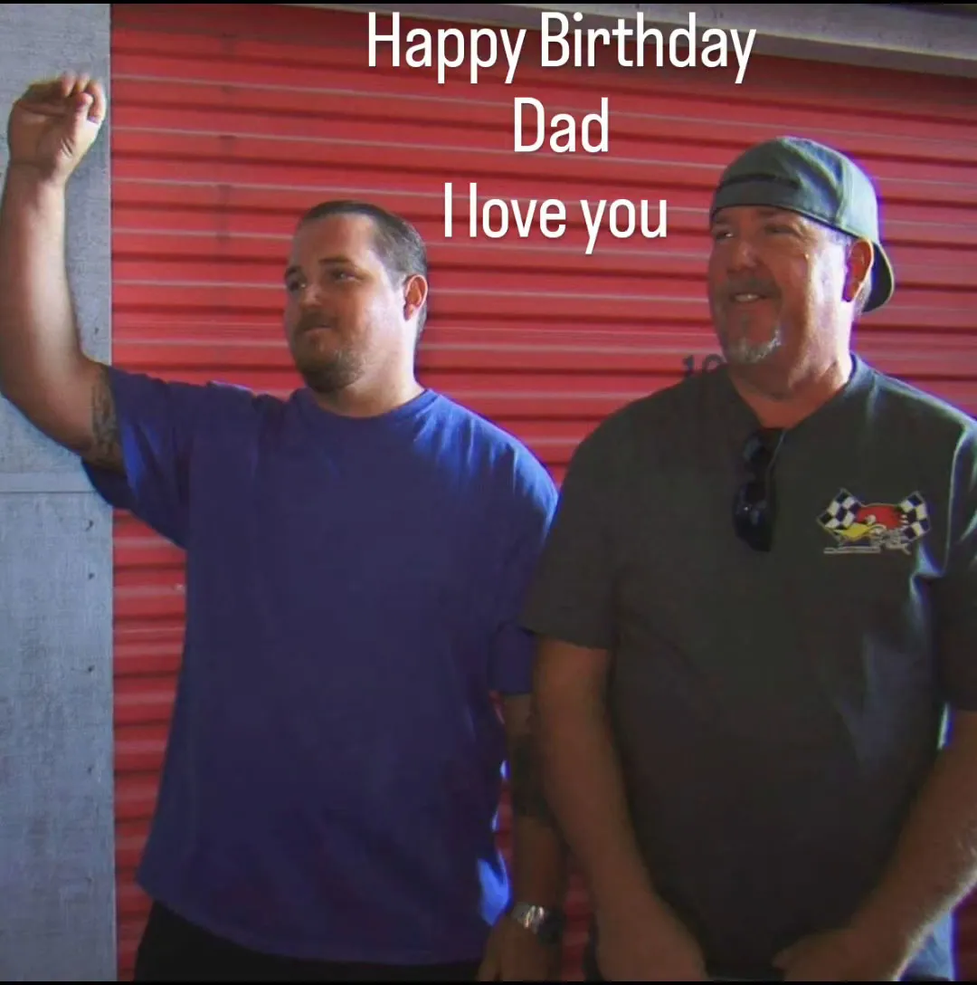 Darrell Sheets and his son Brandon in front of a red storage unit with 