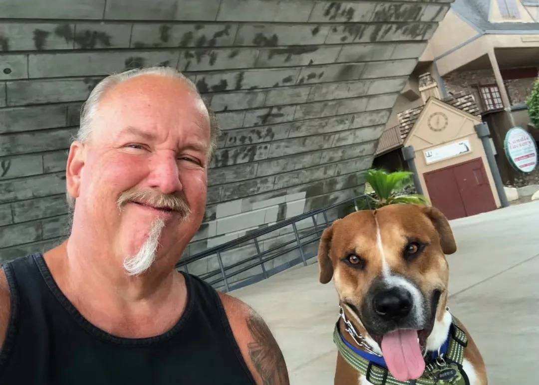 Darrell Sheets smiling with his dog.