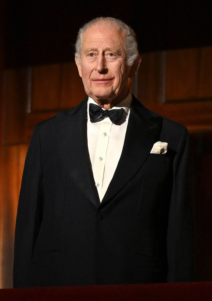 King Charles III in a black tuxedo with a white shirt and bow tie.
