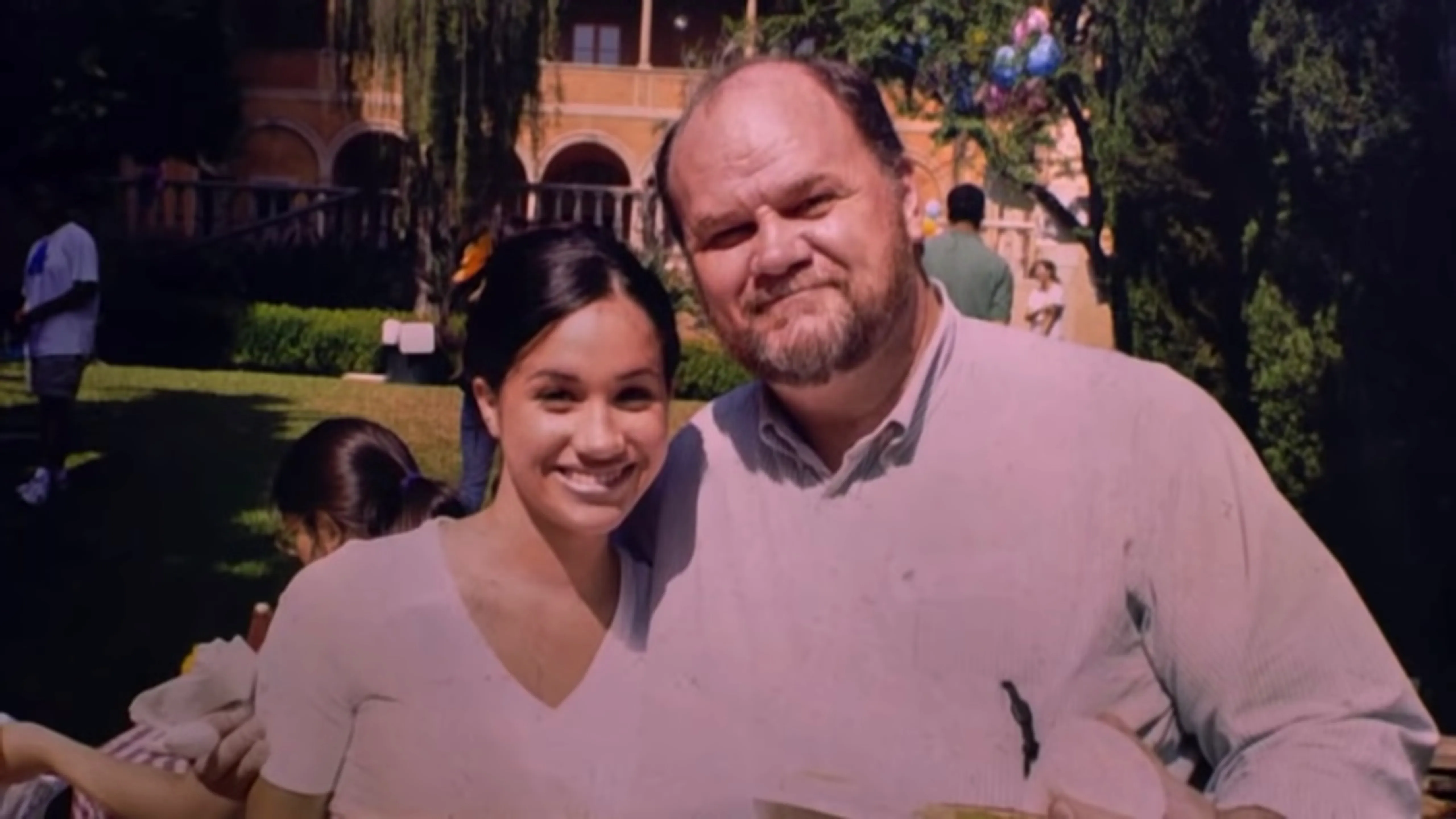 Meghan Markle and her father Thomas Markle posing together outdoors.