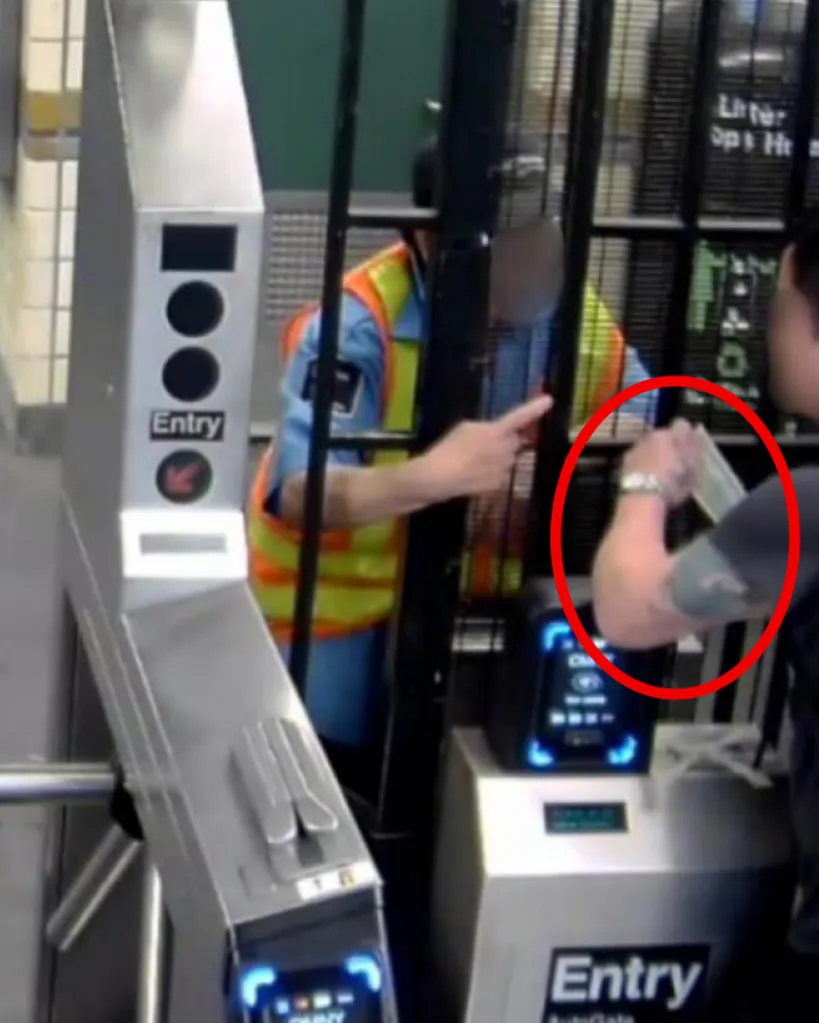 A subway security guard accepting cash from a straphanger while swiping them into the system.