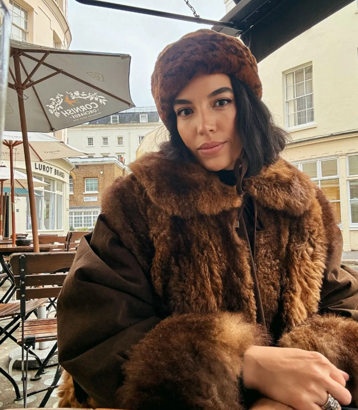 Danielle Olivera wearing a brown fur coat and hat.