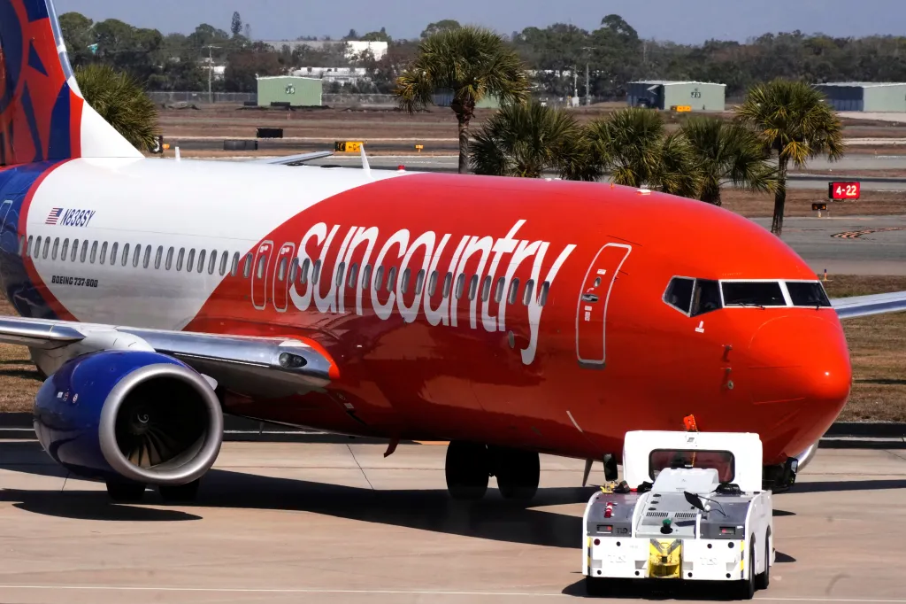 A Sun Country Airlines jet is pushed back from a gate at Sarasota-Bradenton International Airport in Sarasota, Florida.
