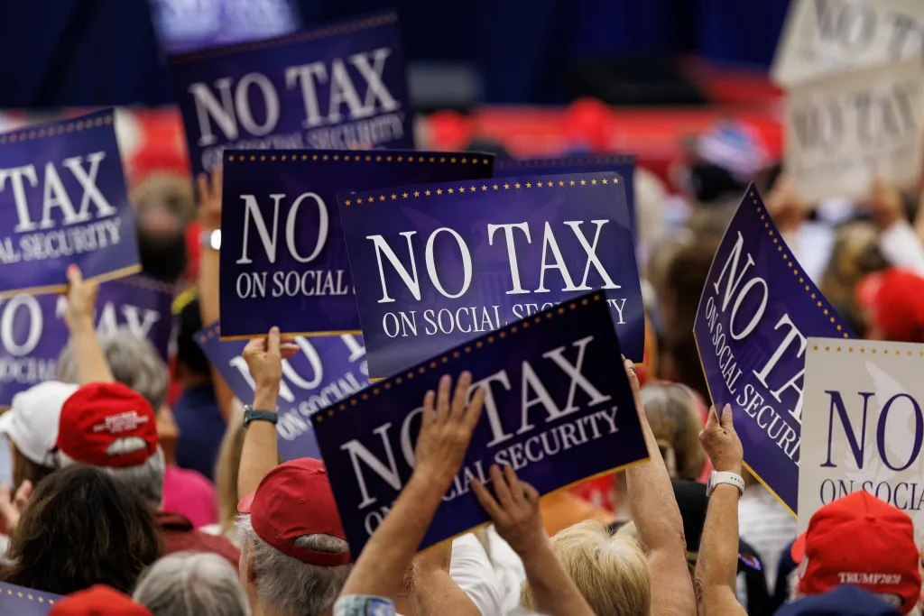 People holding up signs that say 