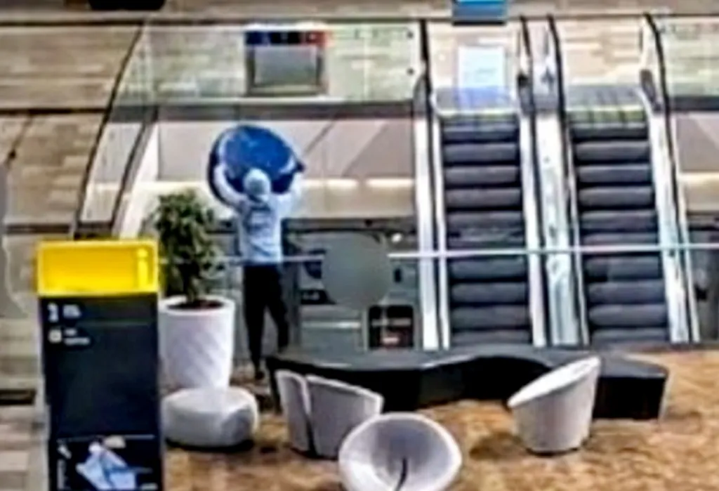 CCTV footage of a person throwing a sofa from a shopping center balcony.