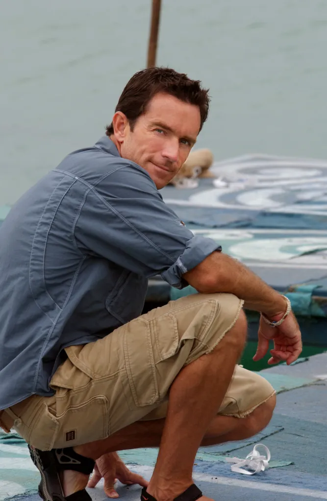 Survivor host Jeff Probst crouching.