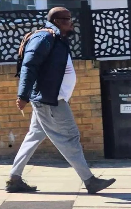 Photograph of 45-year-old Essa Suleiman walking on a sidewalk.