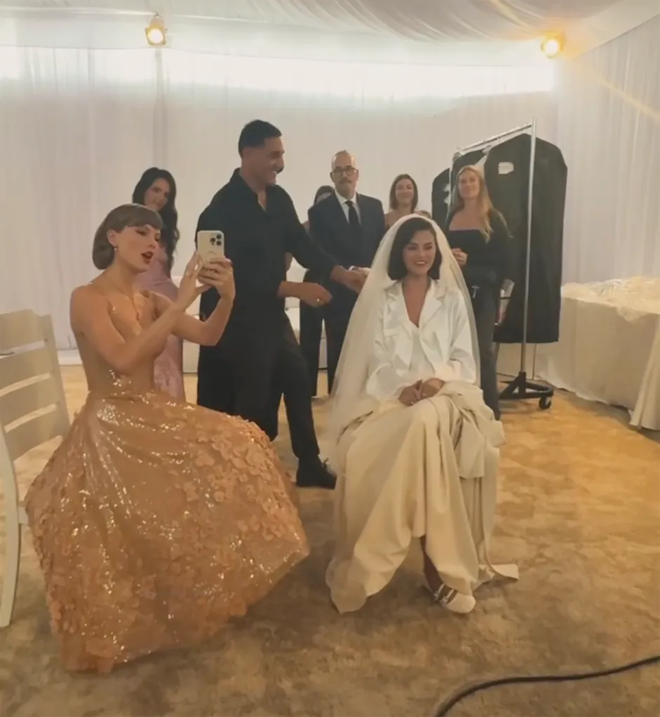 Taylor Swift taking a selfie video with Selena Gomez dressed as a bride.
