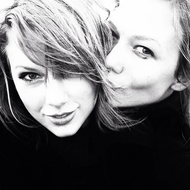 Taylor Swift and Karlie Kloss close together, smiling at the camera.