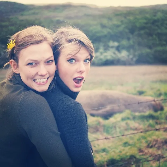 Taylor Swift and Karlie Kloss posing together outdoors.
