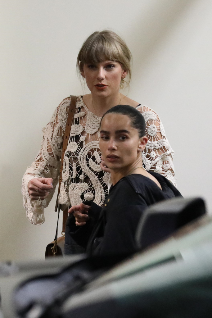Taylor Swift in a white crochet top and Zoe Kravitz in a black hoodie leave Sushi Park.