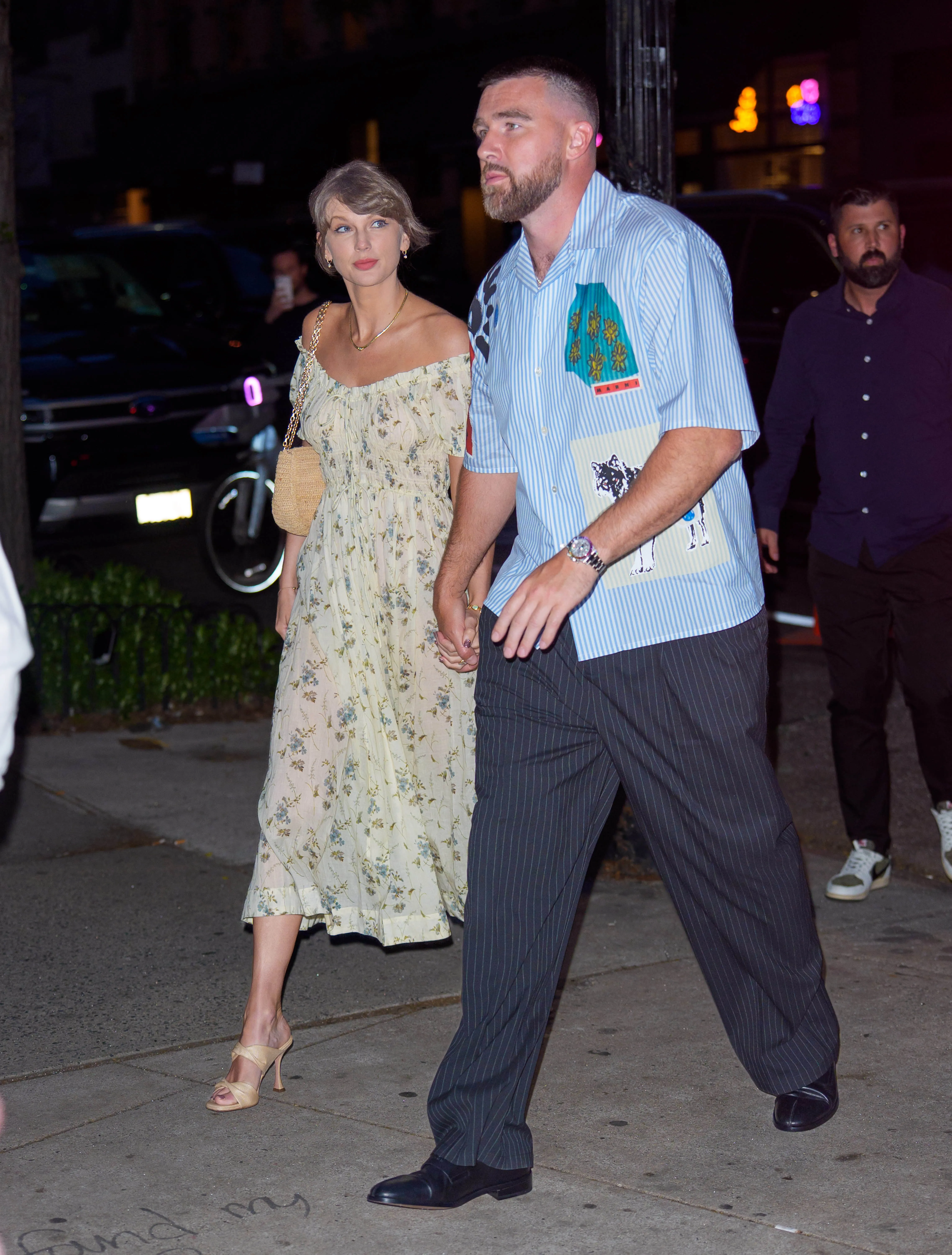 Taylor Swift and Travis Kelce walking hand-in-hand in New York City.