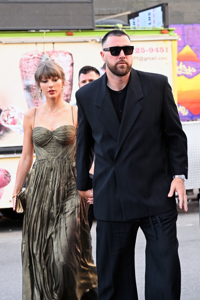 Taylor Swift and Travis Kelce walking hand-in-hand in New York City.