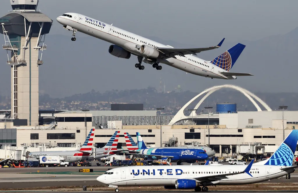 A United Airlines plane takes off as another taxis at Los Angeles International Airport (LAX).