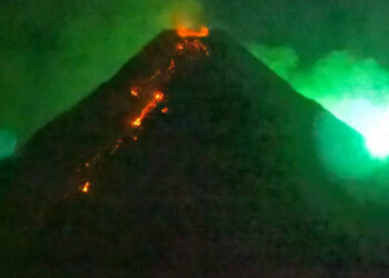 A Fiery Visitor From Space Photo-Bombs an Erupting Volcano
