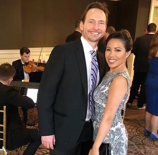Thy and Matthew Mitchell smiling at an event.