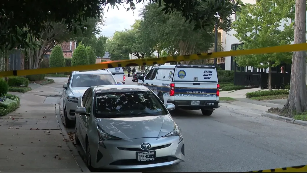 Crime scene units and yellow tape in a residential area.