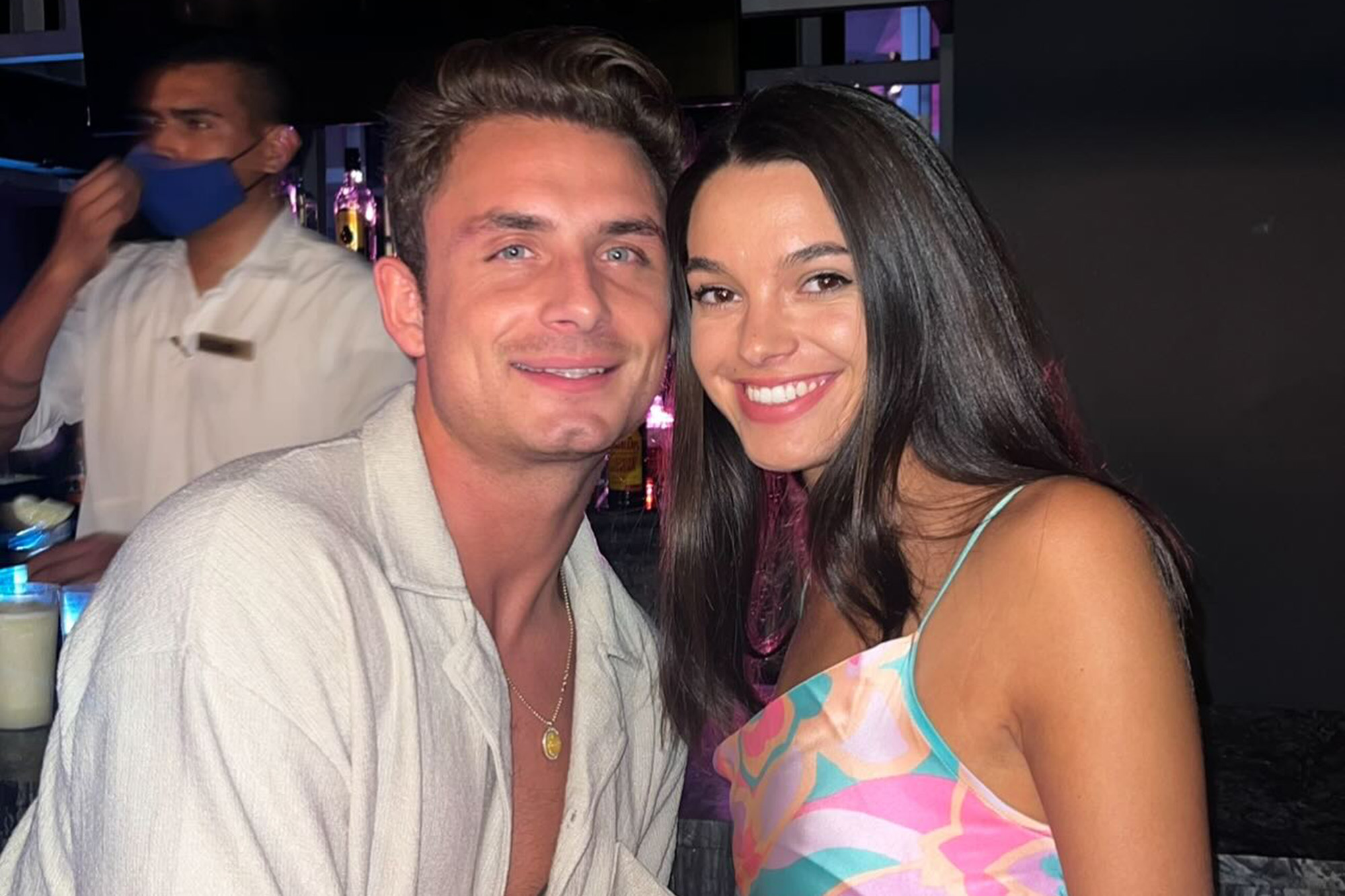 Ally Lewber and James Kennedy smiling at a bar.