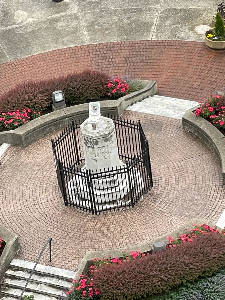 A toilet sitting atop the remains of the Columbus statue in Baltimore's Little Italy.