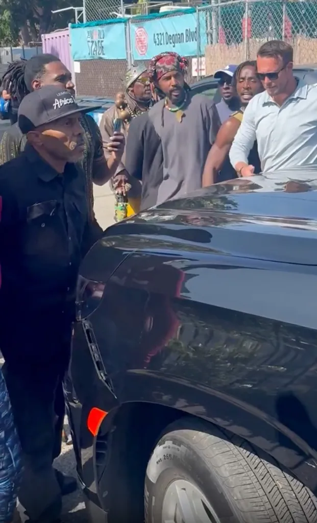 Tom Steyer's SUV is surrounded by protesters in Leimert Park.