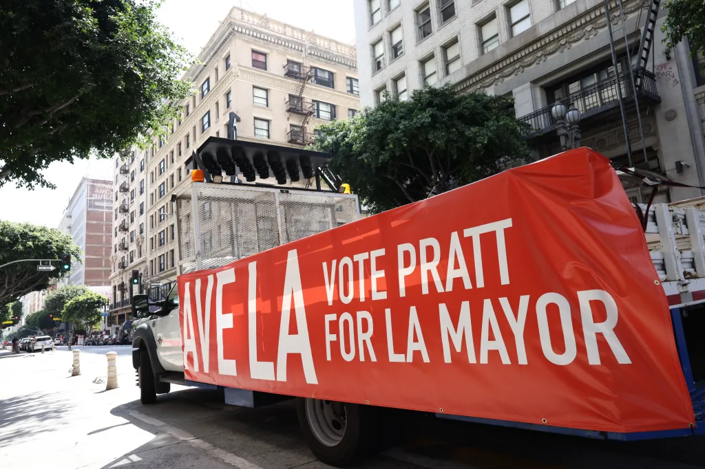 A truck with a large red banner reading 