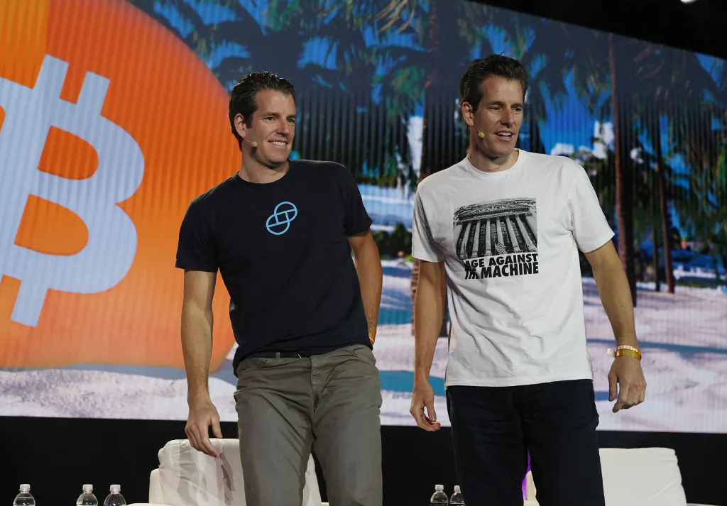 Tyler and Cameron Winklevoss on stage at a Bitcoin convention.