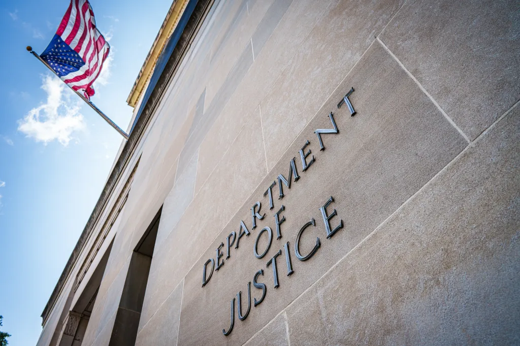 US Flag flies on the side of the US Department of Justice (DOJ) headquarters building.