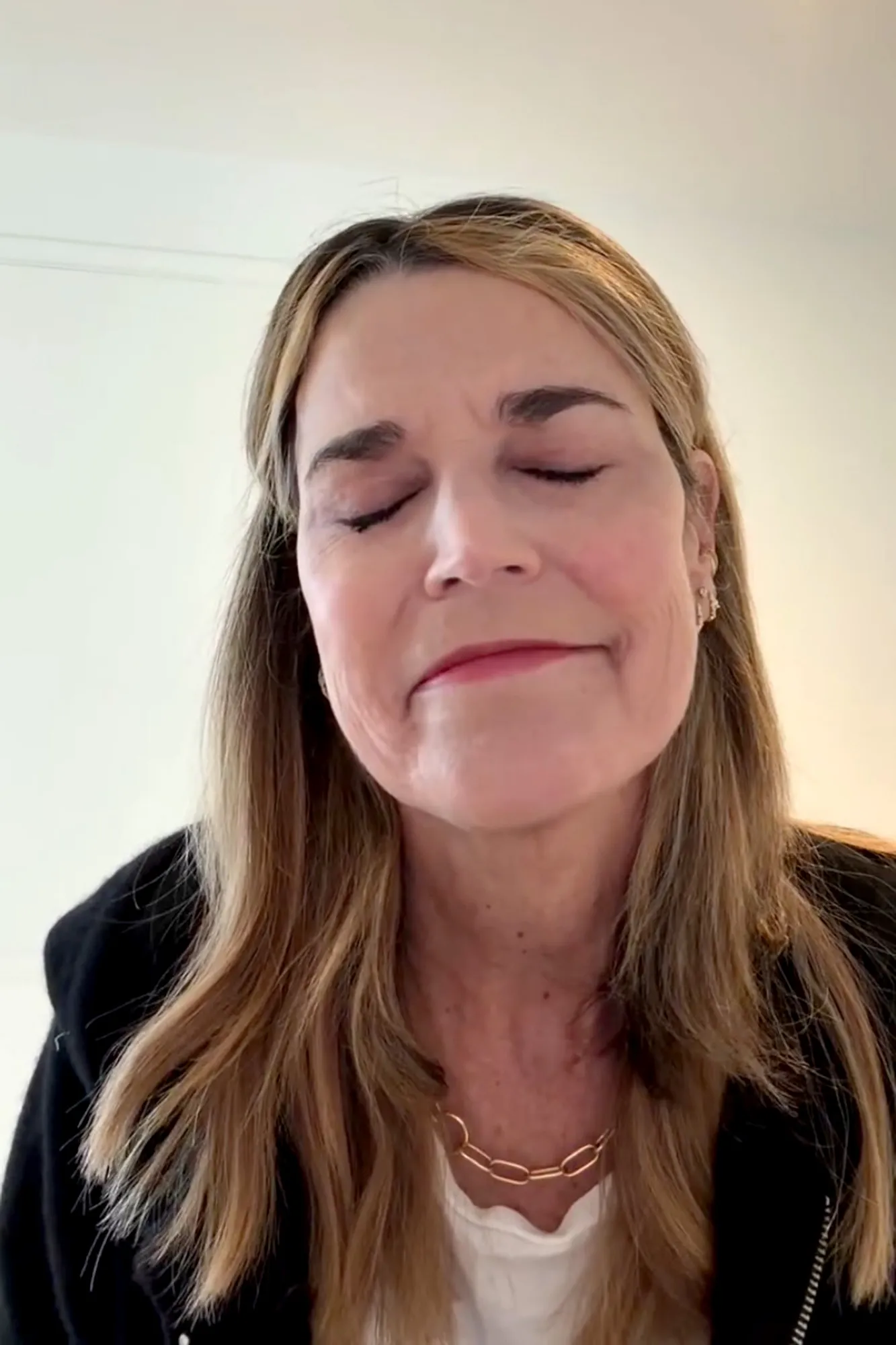 Savannah Guthrie, with her eyes closed, delivers a video message.