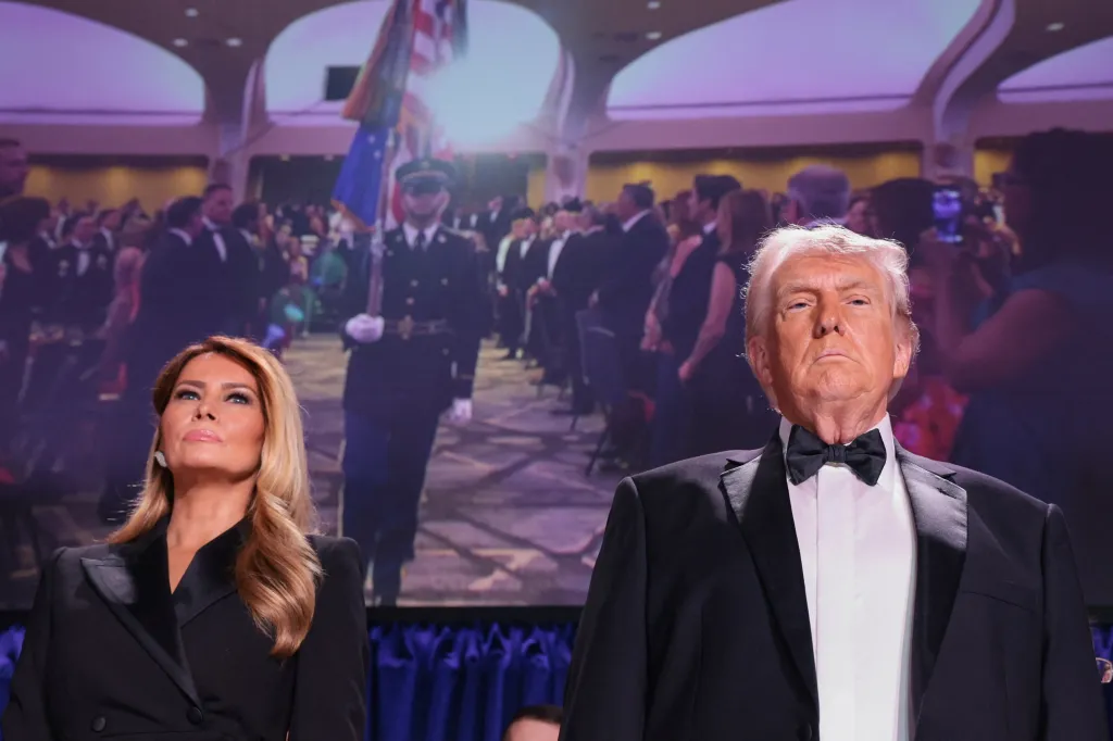 Donald Trump and Melania Trump standing at the White House Correspondents' Association dinner.