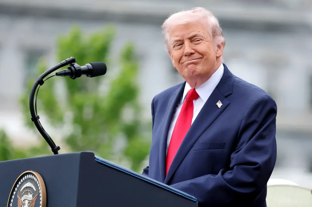 Donald Trump speaking at a podium with a microphone.