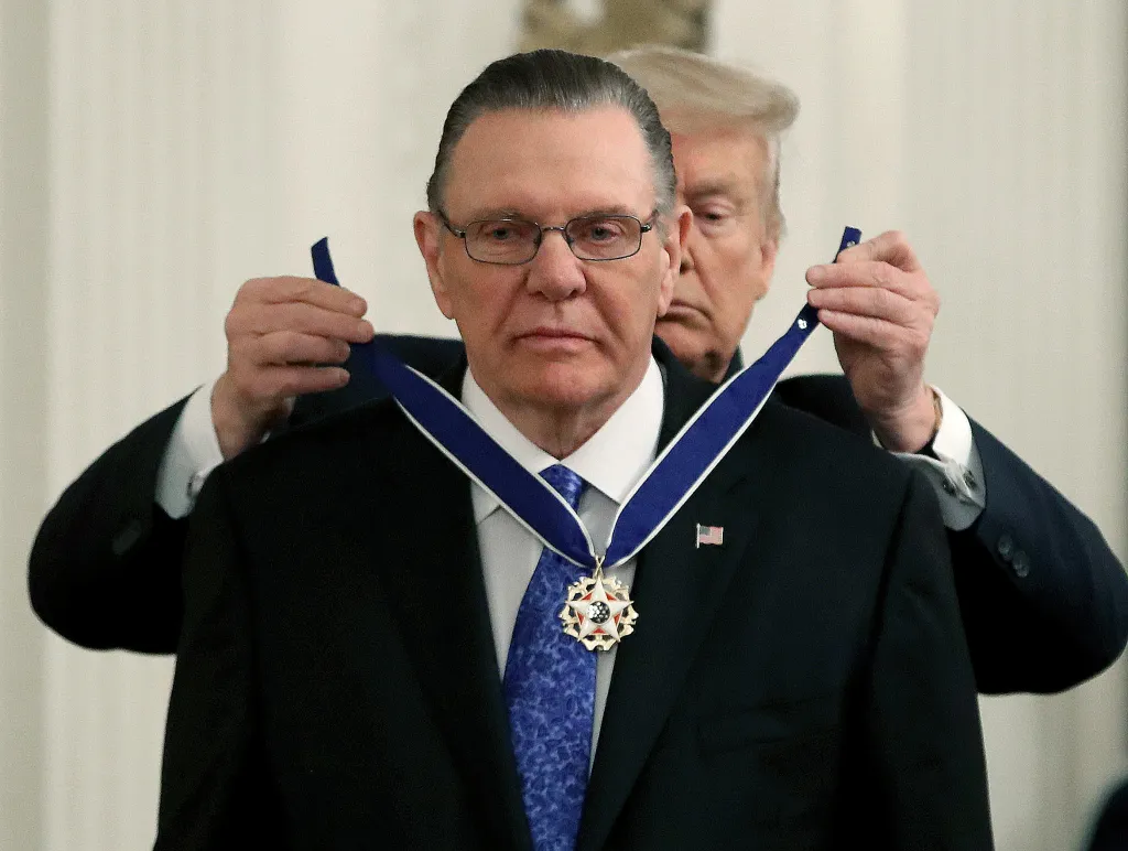 Donald Trump placing the Presidential Medal of Freedom around the neck of General Jack Keane.