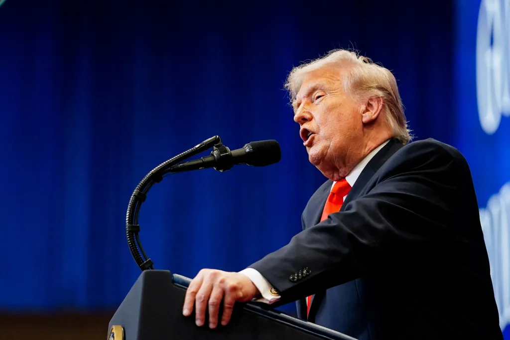 Donald Trump speaking at a podium.