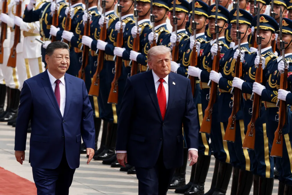 President Donald Trump and President Xi Jinping walking past an honor guard.