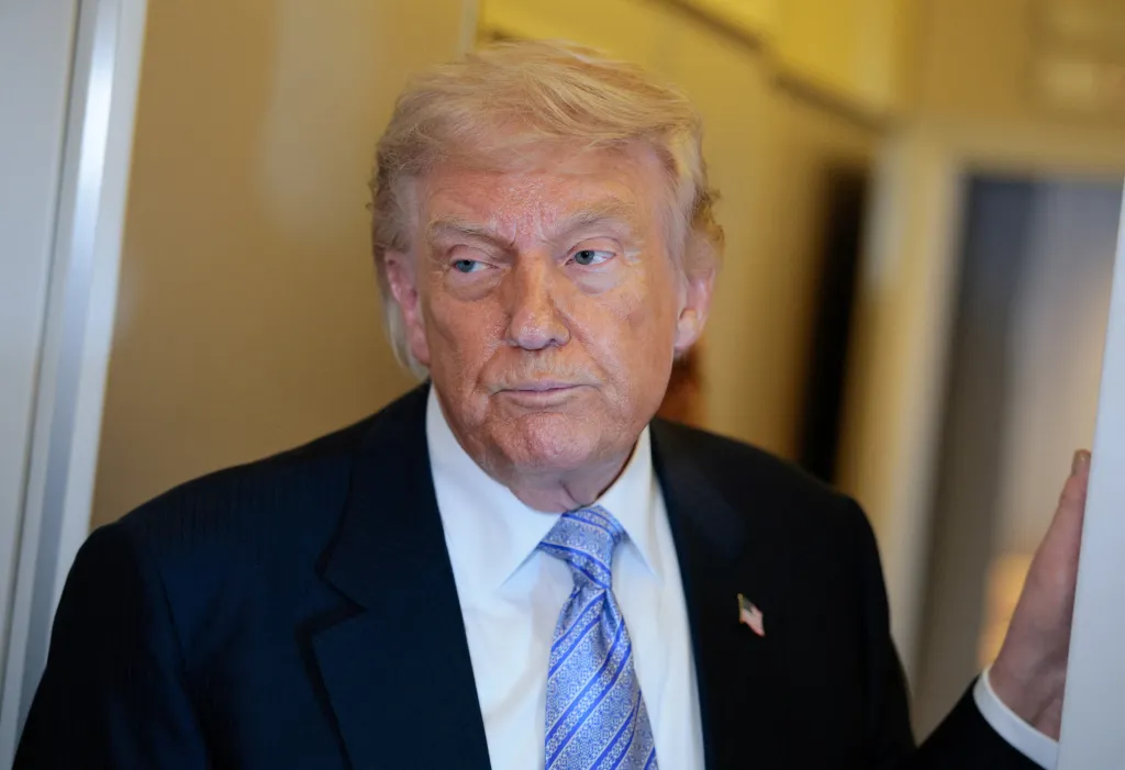 U.S. President Donald Trump speaks to media aboard Air Force One.