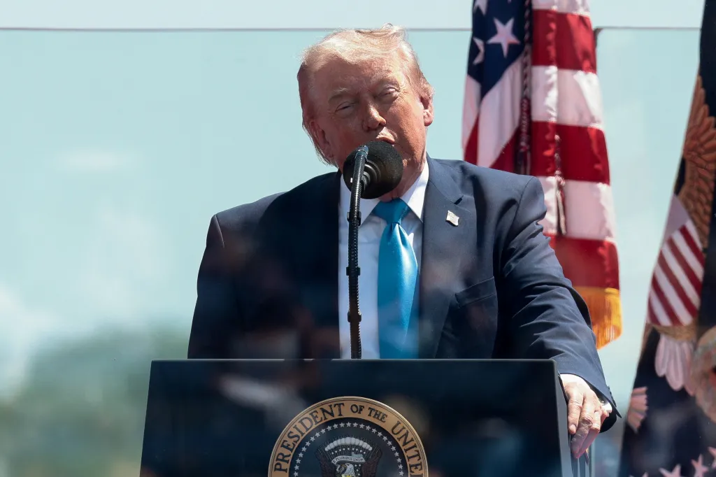 U.S. President Donald Trump behind protective glass delivers the commencement address.