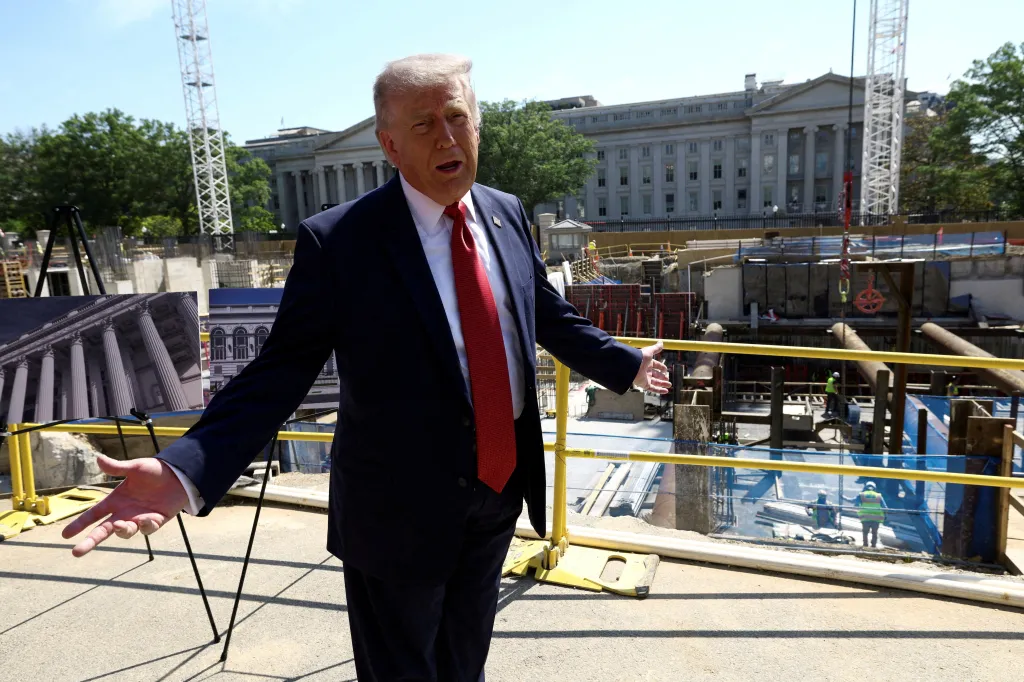 Donald Trump gesturing at the construction site for a White House ballroom.