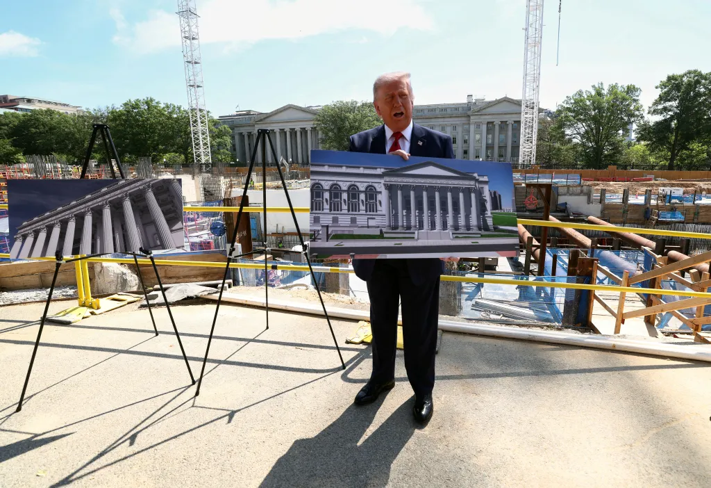 Donald Trump holds a rendering of the planned White House ballroom at the construction site.